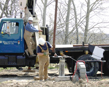 Men drilling a well